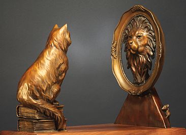 cat looking in mirror lion